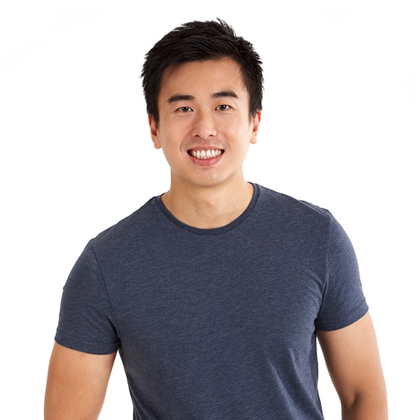 A young man standing smiling