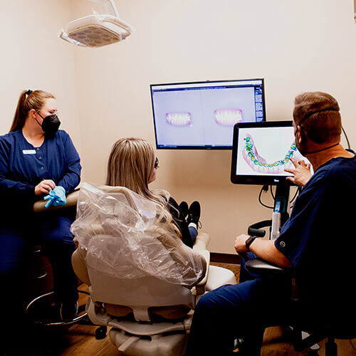 Dr. Jason and one of our assistants showing the results of her exam to a patient