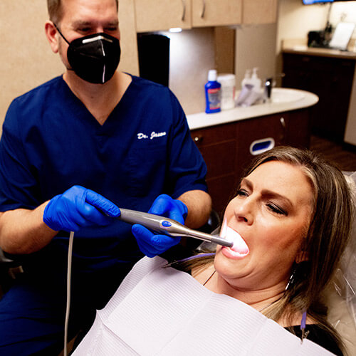 Dr. Jason adding protection to a patient tooth after a root canal procedure.