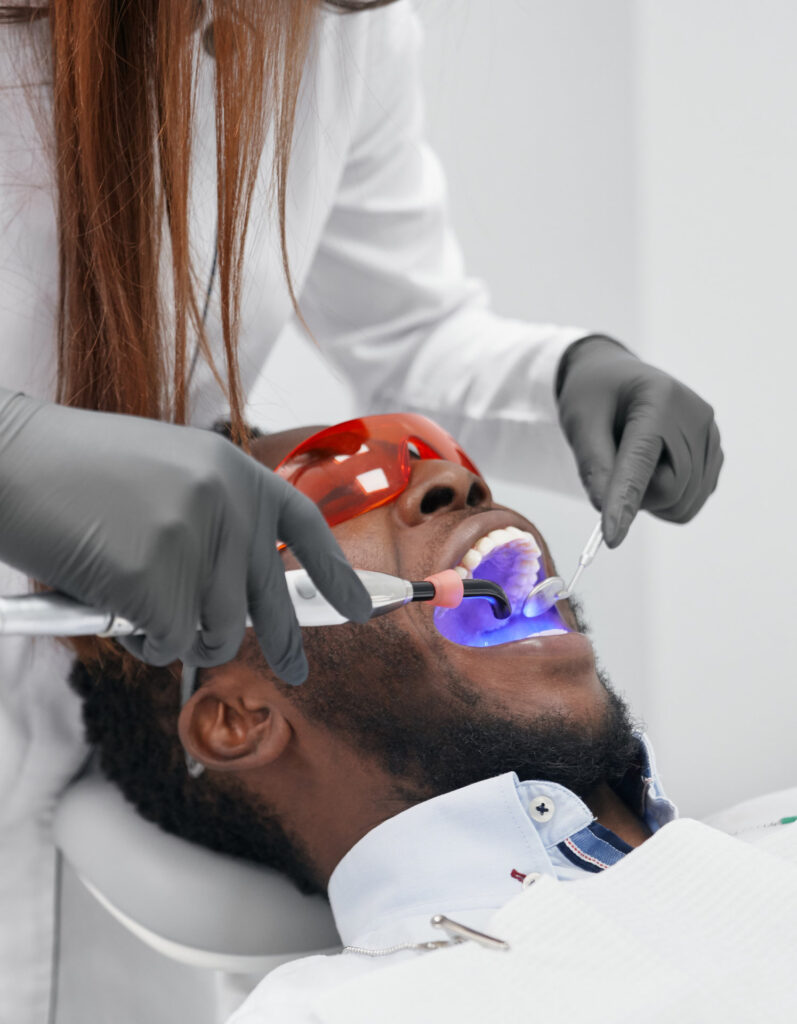 View from side of female doctor in process of doing filling