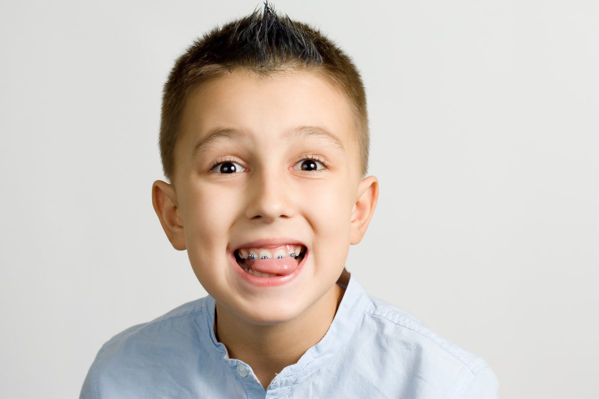 Happy boy showing his bright teeth