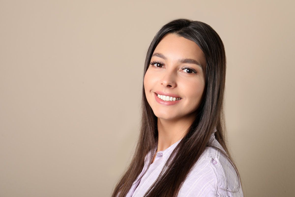 Young woman with healthy teeth on color background.
