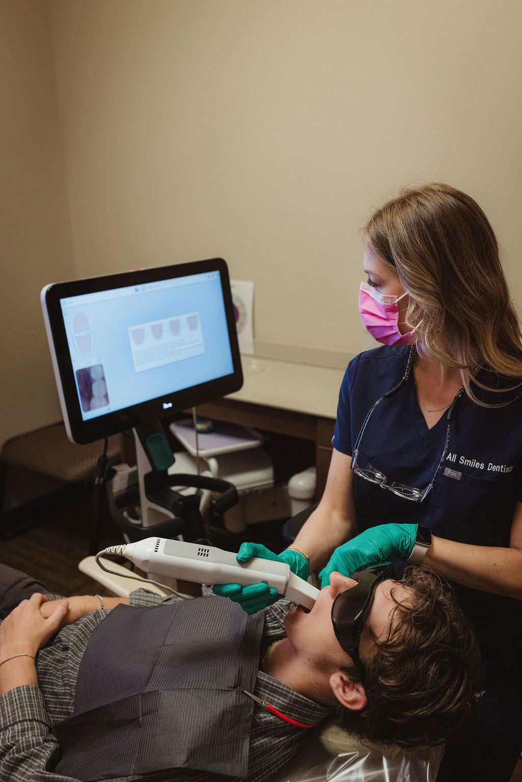 All Smiles Dentistry hygienist performing intraoral scan on young patient