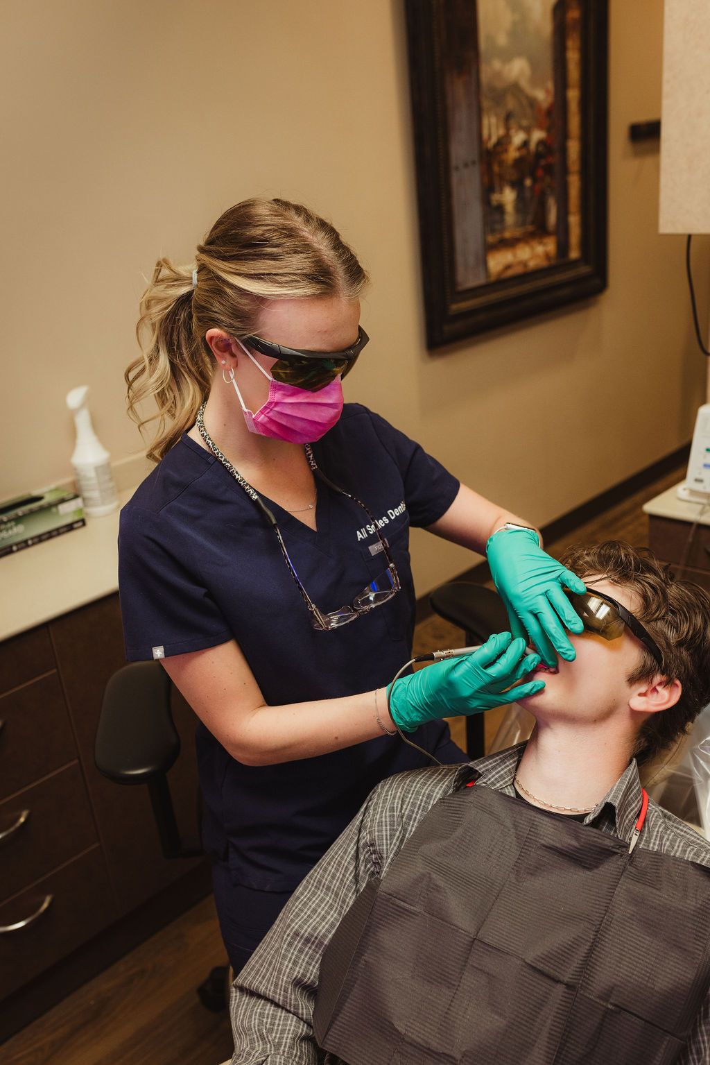 All Smiles Dentistry team member discussing whitening shade options with patient at consultation