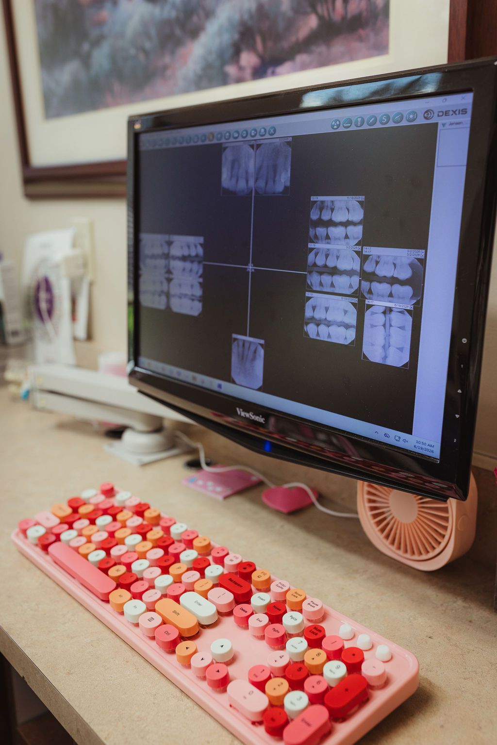 Dental X-ray imaging displayed on monitor with colorful keyboard at All Smiles Dentistry