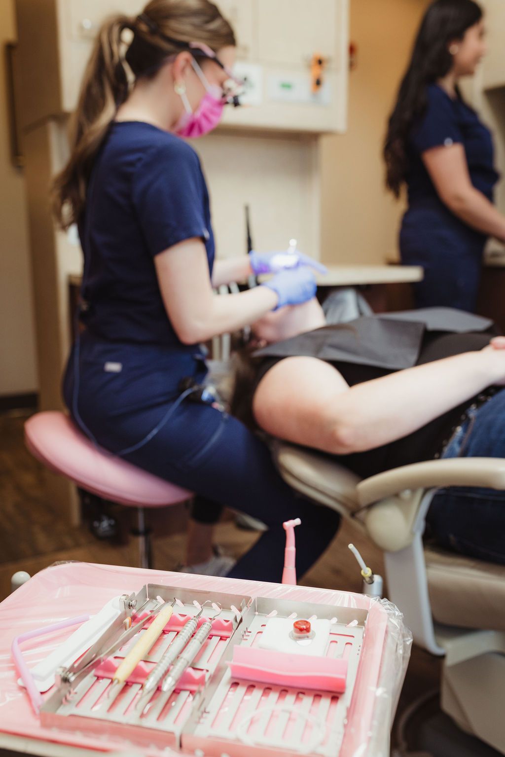 All Smiles Dentistry treatment room with dental instruments and team in background