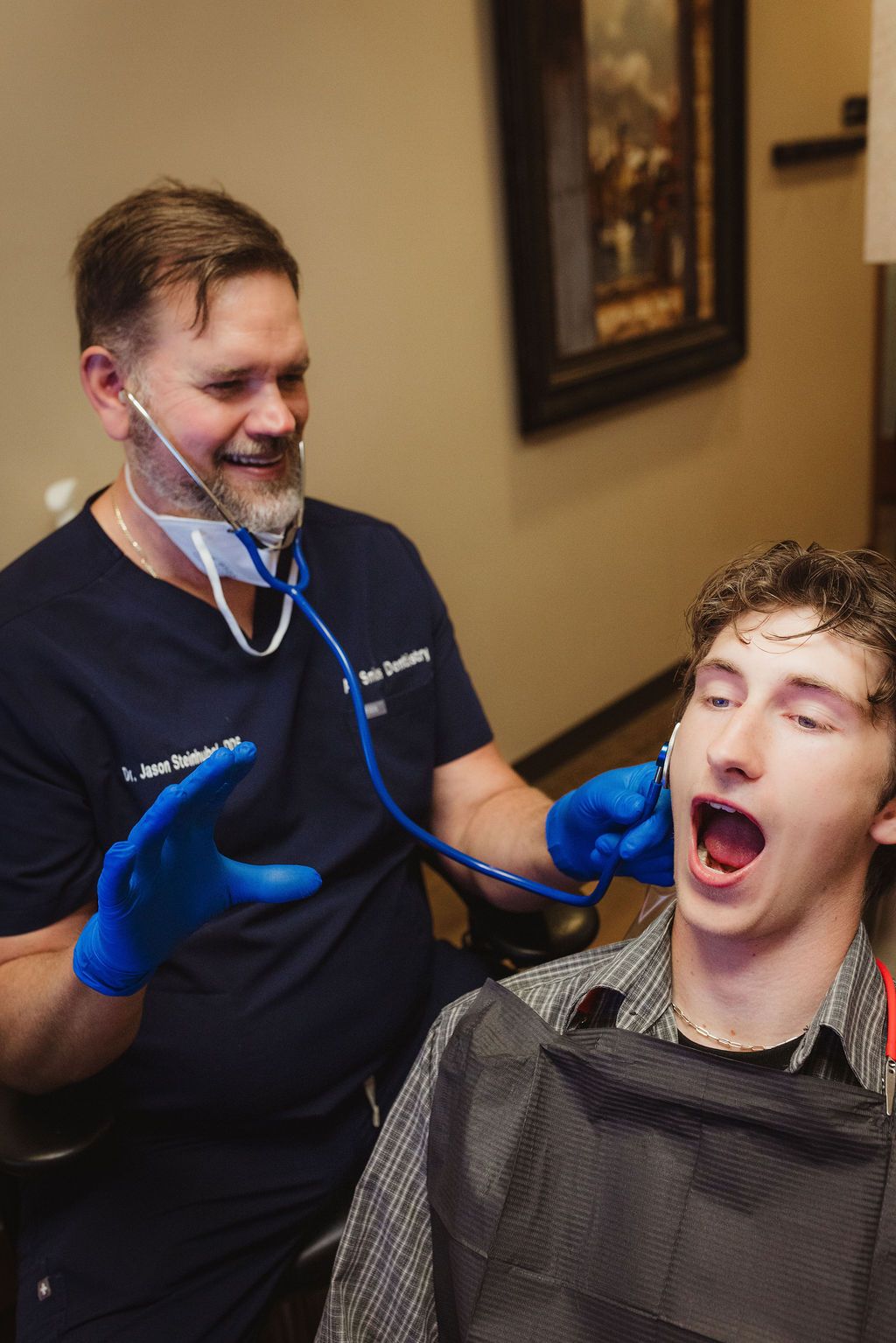 Dr. Jason Steinhubel using stethoscope during patient exam at All Smiles Dentistry