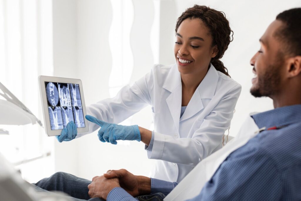 Dentist explaining tooth extraction options to a patient