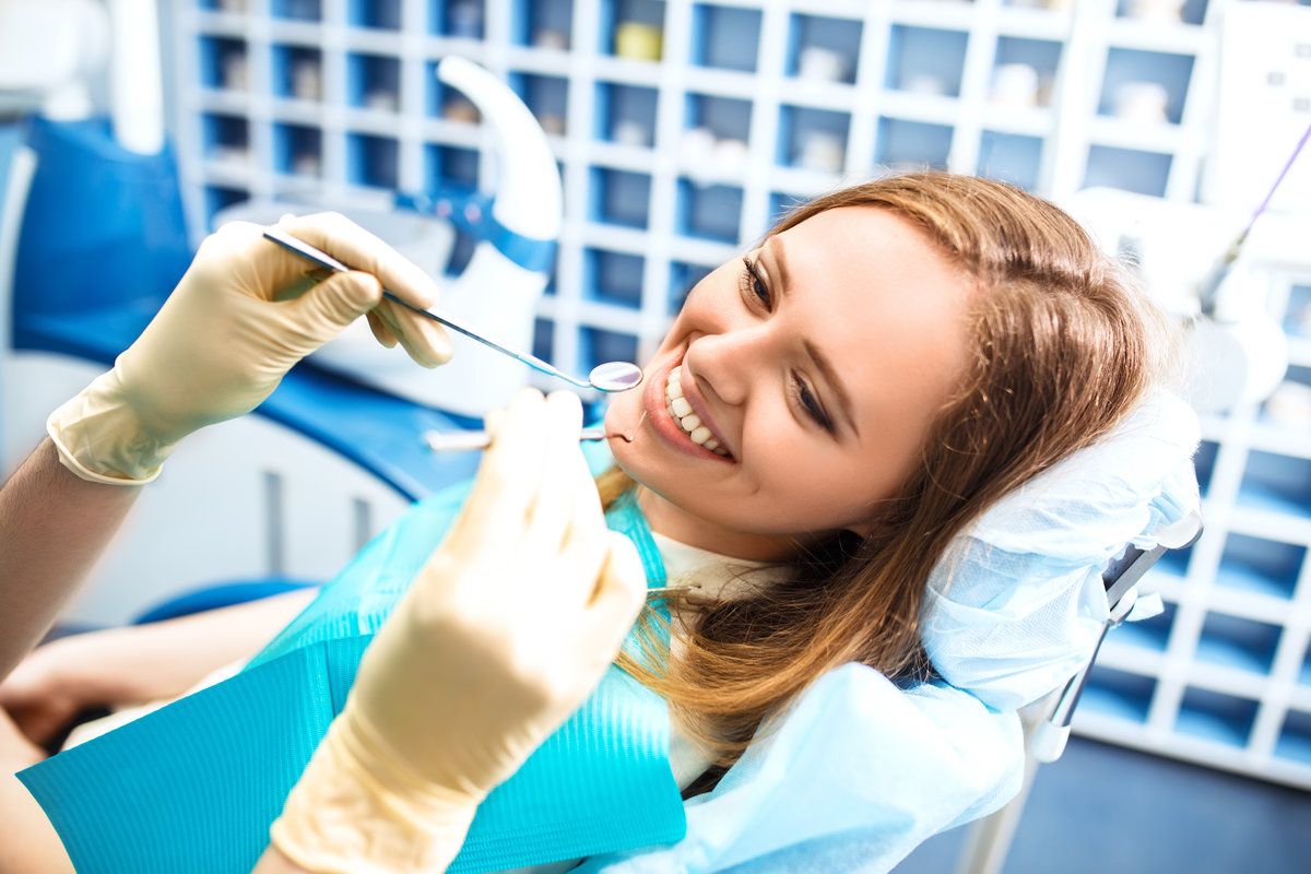 Smiling woman at dental check-up.