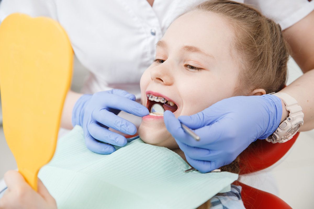 Child receiving dental treatment with braces