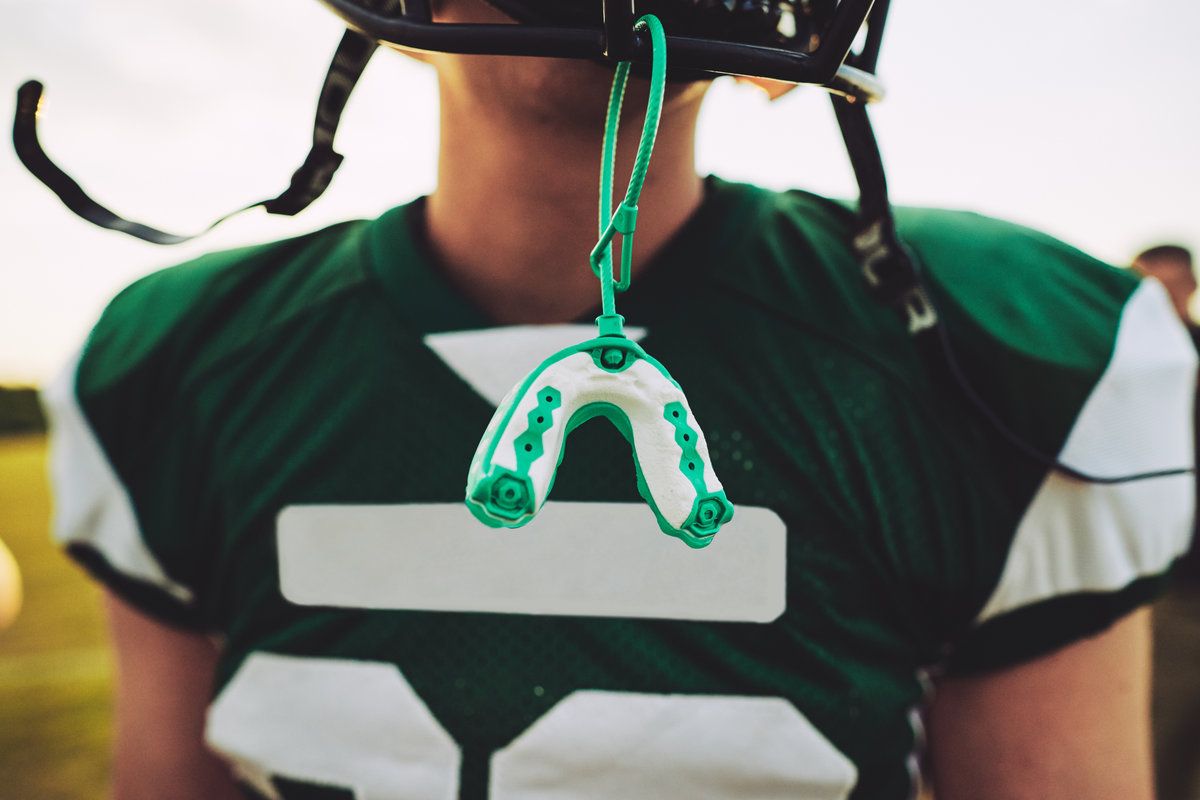 Football player with mouthguard hanging