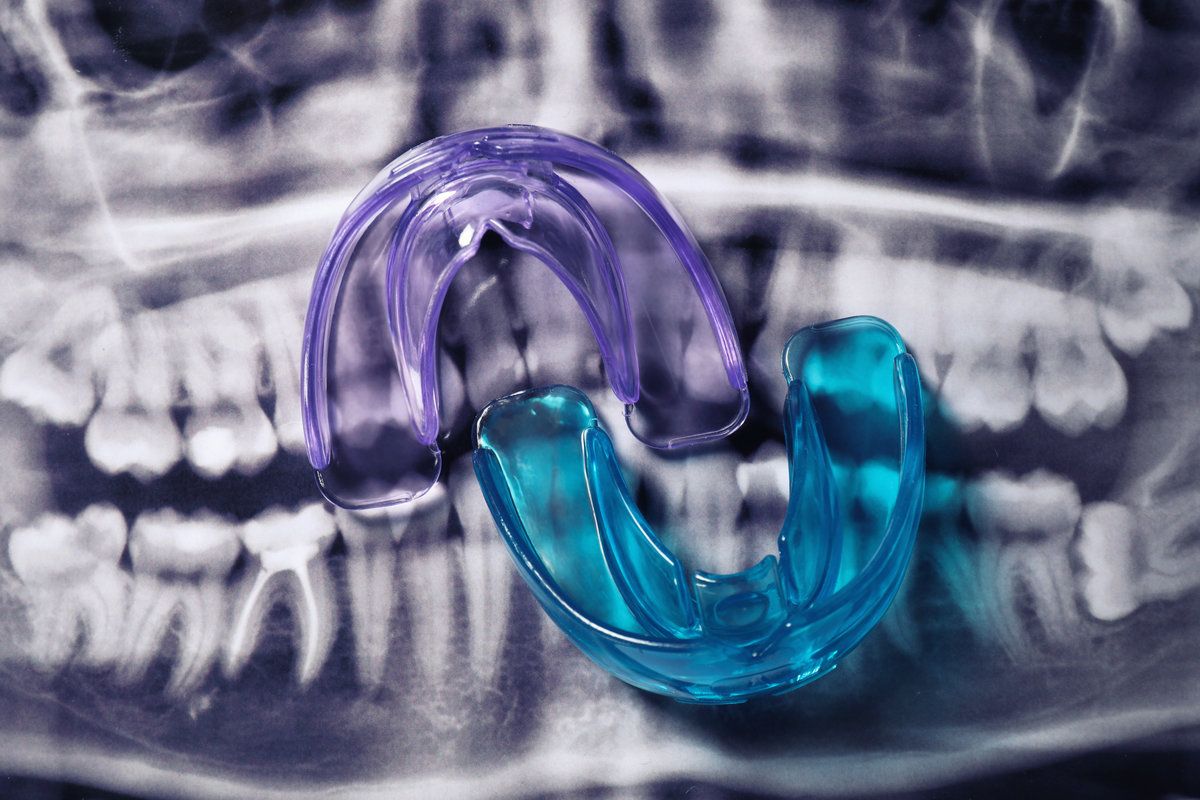 Dental mouthguards on X-ray background